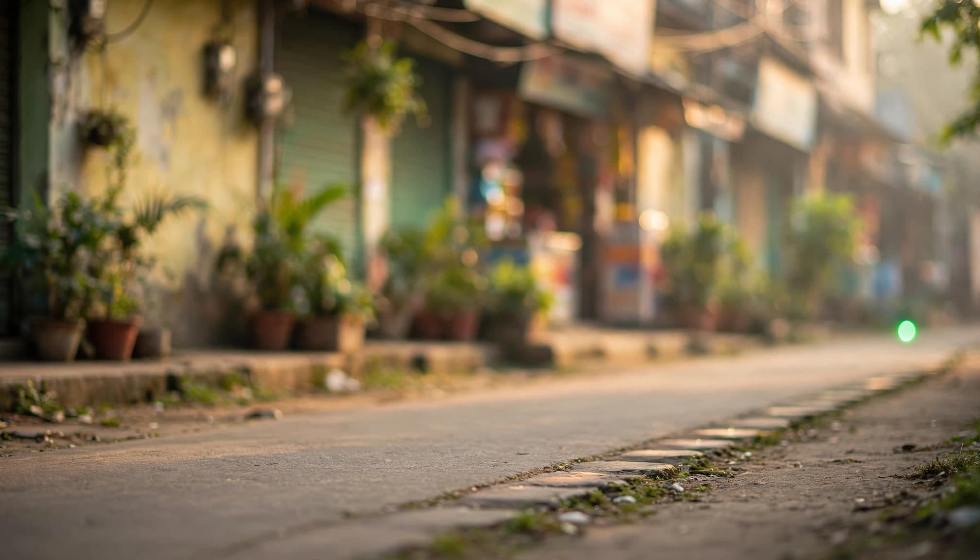 A green point at the end of a path in front of a softly blurred storefront.