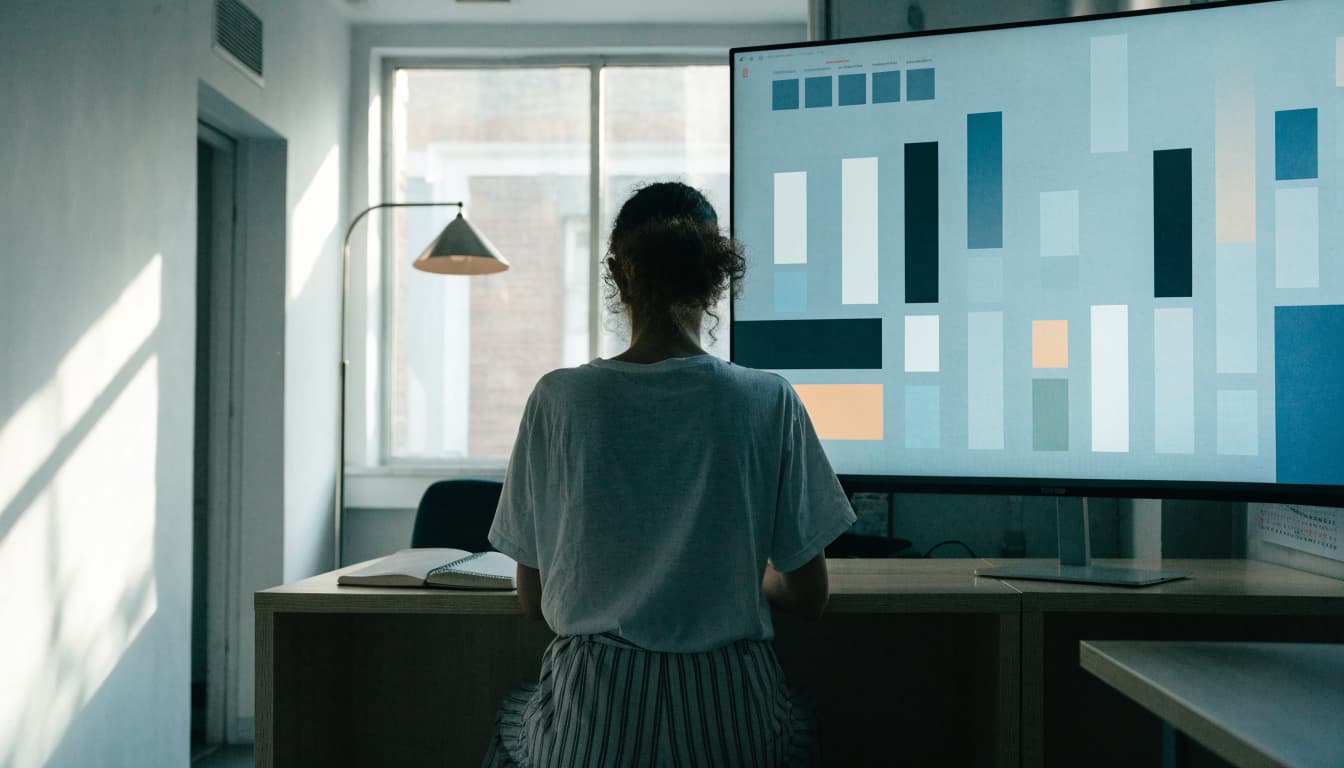 A business owner views simple charts beside a calendar and notebook.