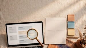A magnifying glass highlights a search result beside a laptop and planning notes.
