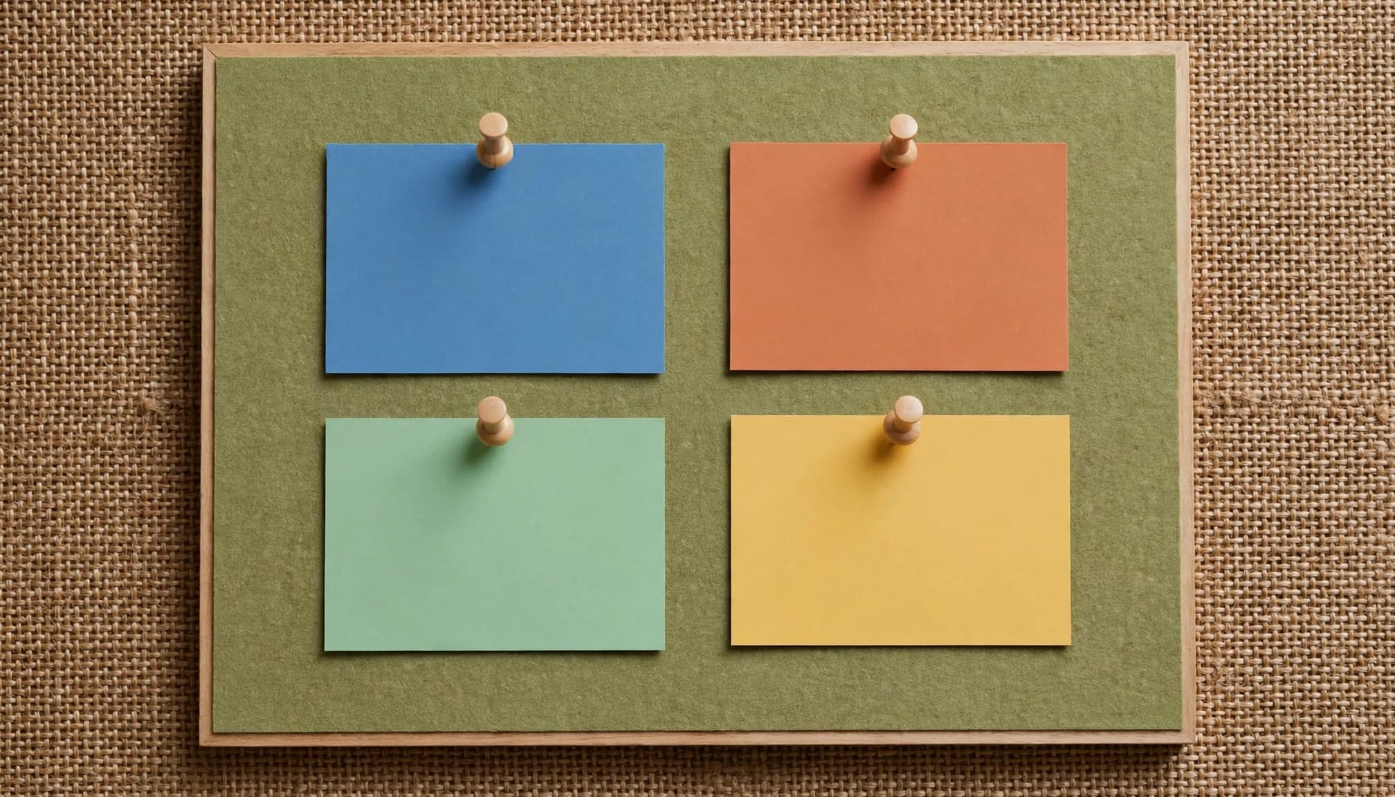 Four blank colored cards arranged neatly on a planning board.